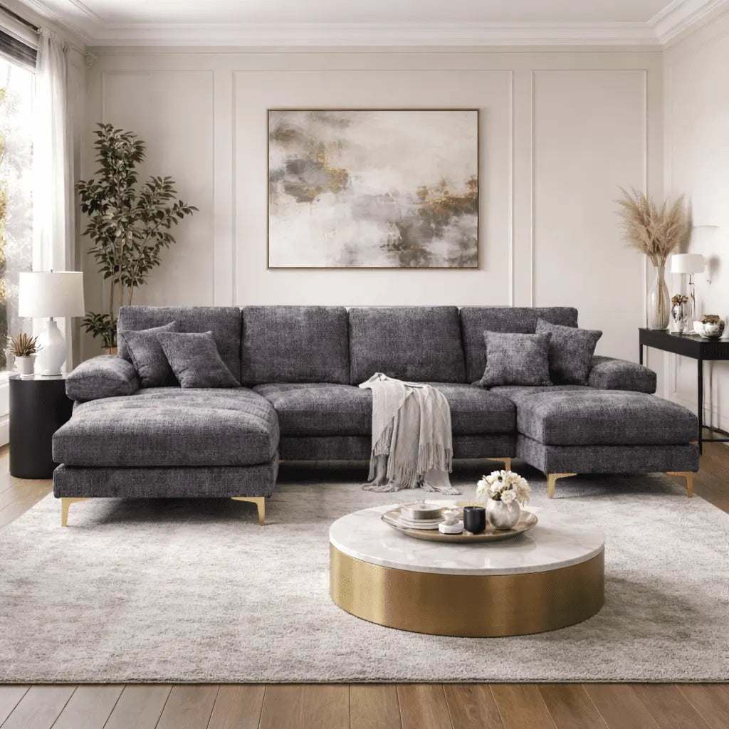 Gray sectional sofa in a modern living room with a coffee table and decorative elements.